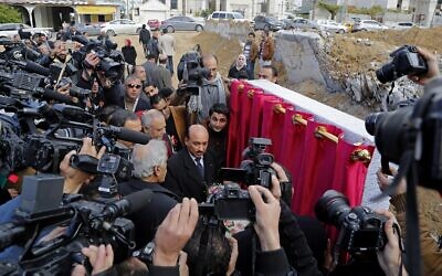 File: Video journalists and photographers work as Mufid Hassayneh, Palestinian minister of public works, center, and Mohammed Abu Haloub of Qatar Charity, unseen, speak during a cornerstone ceremony for rebuilding Zafer 4 Tower in Gaza, in the northern Gaza Strip, on Feb. 18, 2015. (AP Photo/Adel Hana, File)