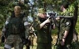 A Russian Army soldier looks through a sniper rifle scope as she and other soldiers guard a group of foreign journalists visiting a captured Ukrainian checkpoint and well-fortified trenches near Schastia town, on the territory which is under the Government of the Luhansk People's Republic control, eastern Ukraine, June 11, 2022. (AP)