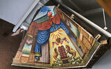 The Lost Mural hangs in the entryway of Ohavi Zedek Synagogue, in Burlington, Vermont, July 29, 2022. The mural painted in 1910 by a Lithuanian immigrant, which was later hidden behind a wall for years, has been rehabilitated and moved and is what experts say is a rare piece of art. (AP Photo/Lisa Rathke)