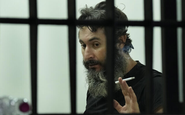 An armed man Bassam al-Sheikh Hussein, 42, right, holds a cigarette as he speaks with one of his hostages inside a bank, in Beirut, Lebanon, August 11, 2022. (AP Photo/Hussein Malla) An armed man Bassam al-Sheikh Hussein, 42, right, holds a cigarette as he speaks with one of his hostages inside a bank, in Beirut, Lebanon, August 11, 2022. (AP Photo/Hussein Malla)