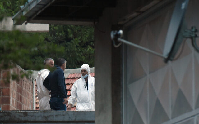 Police investigators on the site of the attack in Cetinje, 36 kilometers (22 miles) west of Podogrica, Montenegro, Friday, August 12, 2022. (AP Photo/Risto Bozovic)