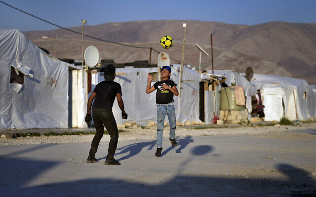 Syrian children play soccer near their tented homes at a refugee camp in the town of Bar Elias, in the Bekaa Valley, Lebanon, July 7, 2022. (AP Photo/ Bilal Hussein, File) Syrian children play soccer near their tented homes at a refugee camp in the town of Bar Elias, in the Bekaa Valley, Lebanon, July 7, 2022. (AP Photo/ Bilal Hussein, File)