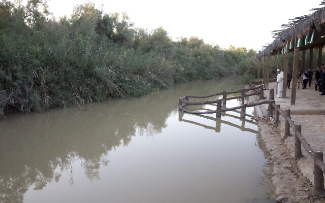 Pope Francis prays in front of the Jordan River at the Bethany beyond the Jordan baptismal site on the east bank of the river, west of Amman, Jordan, May 24, 2014. (Andrew Medichini/AP)