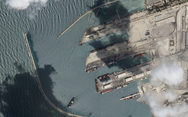This satellite image from Planet Labs PBC shows the Sierra Leone-flagged cargo ship Razoni, center bottom with four white cranes on its red deck, at port in Tartus, Syria, Monday, Aug. 15, 2022. (Planet Labs PBC via AP) This satellite image from Planet Labs PBC shows the Sierra Leone-flagged cargo ship Razoni, center bottom with four white cranes on its red deck, at port in Tartus, Syria, Monday, Aug. 15, 2022. (Planet Labs PBC via AP)