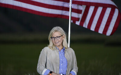 Liz Cheney, a Republican Congresswoman from Wyoming, stands by flags as she waits to speak at a primaries day gathering, Jackson, Wyoming, August 16, 2022. (AP/Jae C. Hong)