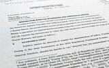 A court filing by lawyers for former US president Donald Trump is photographed on August 22, 2022, as lawyers ask a federal judge to prevent the FBI from continuing to review documents recovered from his Florida estate until a neutral special master can be appointed. (AP Photo/Jon Elswick)