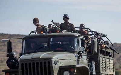 Ethiopian government soldiers ride in the back of a truck on a road near Agula, north of Mekele, in the Tigray region of northern Ethiopia on May 8, 2021. (Ben Curtis/AP)