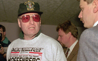 Steven Hoffenberg, left, is escorted by FBI agents in a Little Rock, Ark. parking garage after turning himself in, Feb. 15, 1996. (AP Photo/Danny Johnston, File)