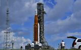 Photographers place remote cameras near the Artemis 1 rocket as she stands on Launch Pad 39-B at the Kennedy Space Center at Cape Canaveral, Florida, August 26, 2022. (AP/Brynn Anderson)