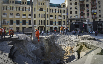A view of a crater from a night Russian rocket attack, near to damaged buildings in downtown Kharkiv, Ukraine, Aug. 27, 2022. (AP/Andrii Marienko)