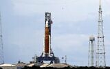 The NASA moon rocket stands ready less than 24 hours before it is scheduled to launch on Pad 39B for the Artemis 1 mission to orbit the moon at the Kennedy Space Center, Aug. 28, 2022, in Cape Canaveral, Fla. (AP Photo/John Raoux)