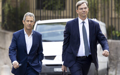 Israeli diamond magnate Beny Steinmetz, left, with his lawyer Daniel Kinzer arrives at a courthouse in Geneva, Switzerland, August 29, 2022. (Salvatore Di Nolfi/Keystone via AP)