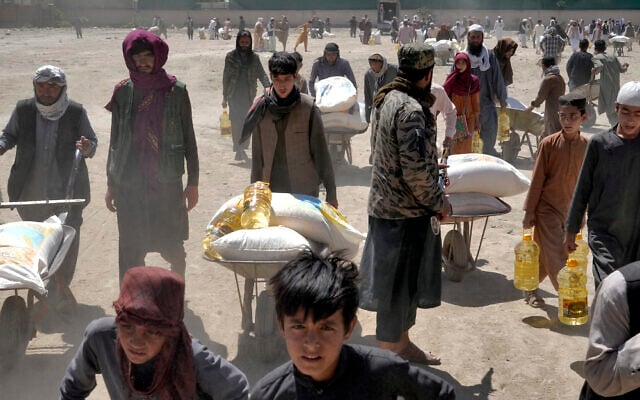 A Taliban fighter stands guard as people receive food rations distributed by a Chinese humanitarian aid group, in Kabul, Afghanistan, April 30, 2022. (Ebrahim Noroozi/AP) A Taliban fighter stands guard as people receive food rations distributed by a Chinese humanitarian aid group, in Kabul, Afghanistan, April 30, 2022. (Ebrahim Noroozi/AP)