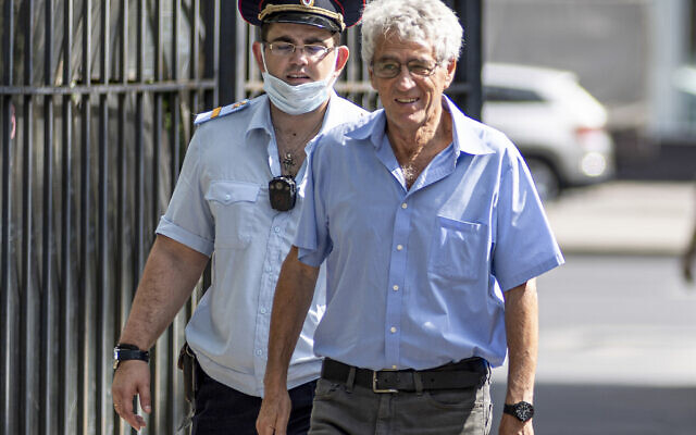 Leonid Gozman, a liberal politician, walks escorted by a police officer in Moscow, Russia, on July 25, 2022. (AP Photo/Alec Sander)