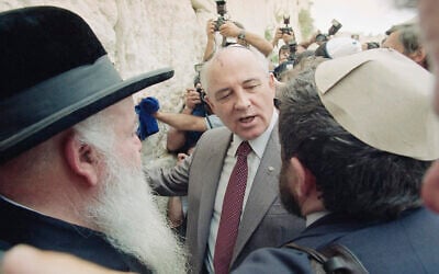 Former Soviet president Mikhail Gorbachev, center, is escorted to the Western Wall in Jerusalem's Old City, June 18, 1992. Gorbachev was concluding a five-day private visit to Israel. (AP Photo/Jerome Delay)