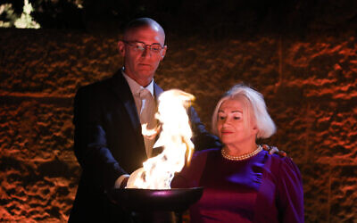 Illustrative: A Holocaust survivor lights a torch during a ceremony held at the Yad Vashem Holocaust Memorial Museum in Jerusalem on Israel's annual Holocaust Remembrance Day, April 7, 2021. (Olivier Fitoussi/Flash90)