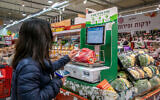 Illustrative: A shopper at a Rami Levy supermarket in Modiin on February 1, 2022. (Yossi Aloni/Flash90)