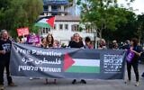 Illustrative: Demonstrators waving Palestinian flags protest the IDF's Operation Breaking Dawn, outside the Defense Ministry in Tel Aviv, August 6, 2022. (Tomer Neuberg/Flash90)