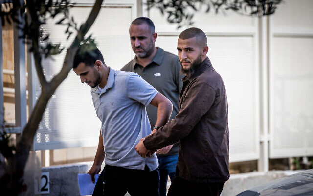 Amir Sidawi is escort by police as he arrives to a court hearing at the Jerusalem Magistrate's Court on August 14, 2022. (Yonatan Sindel/Flash90) Amir Sidawi is escort by police as he arrives to a court hearing at the Jerusalem Magistrate's Court on August 14, 2022. (Yonatan Sindel/Flash90)