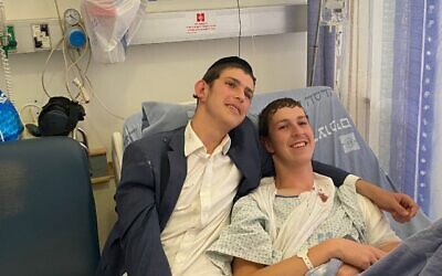 Elazar, 19, (right) and Dovi, 16, (left) are seen at the Hadassah Mount Scopus hospital, after the pair were wounded in a shooting attack in Jerusalem, August 14, 2022. (Courtesy)
