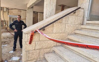Police at a Ramot property August 13, 2022, after reports a young boy was found with strangulation marks on his neck. The boy was pronounced dead the following day. (Israel Police)