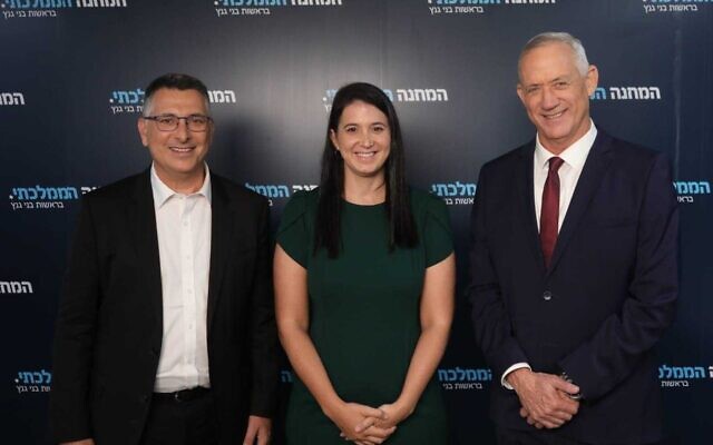 In this handout photo released by National Unity on August 22, 2022, leaders Benny Gantz (R) and Gideon Sa'ar (l) pose with the party's newest member, MK Shirly Pinto (C). (Elad Malka) In this handout photo released by National Unity on August 22, 2022, leaders Benny Gantz (R) and Gideon Sa'ar (l) pose with the party's newest member, MK Shirly Pinto (C). (Elad Malka)