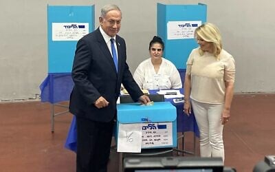 Then opposition leader Benjamin Netanyahu and his wife, Sara, cast their votes in the Likud primary in Tel Aviv, August 10, 2022. (Carrie Keller-Lynn/Times of Israel) Then opposition leader Benjamin Netanyahu and his wife, Sara, cast their votes in the Likud primary in Tel Aviv, August 10, 2022. (Carrie Keller-Lynn/Times of Israel)