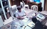 Petah Tikva Mayor Rami Greenberg is filmed apparently receiving a stack of cash in a clip released on August 14, 2022. (Screen capture/Channel 12)