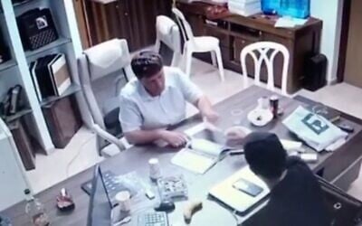 Petah Tikva Mayor Rami Greenberg is filmed apparently receiving a stack of cash in a clip released on August 14, 2022. (Screen capture/Channel 12)
