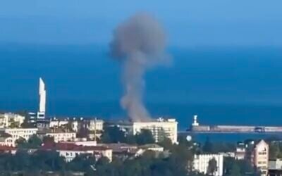 A screenshot of video from social media purporting to show a blaze on the roof of Russia's Black Sea fleet headquarters, in Sevastopol, Russian-annexed Crimea, August 2022. The governor of Sevastopol said the drone was downed and then crashed into the roof, sparking the fire. (Screen capture: Twitter)