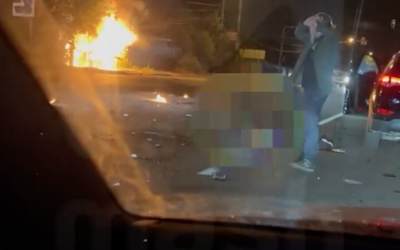 Screen capture from video purportedly showing Russian nationalist philosopher Alexander Dugin watching at the scene where his daughter Darya Dugina died in a car-bombing near Moscow, August 20, 2022. (Twitter)