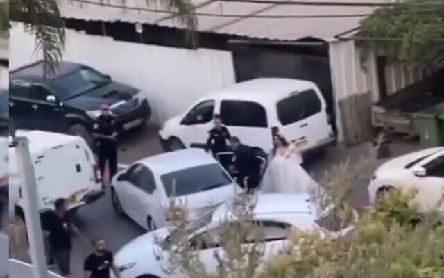 A bride is detained by police in her wedding dress in the town of Arraba in the Lower Galilee on August 28. 2022 (screenshot) A bride is detained by police in her wedding dress in the town of Arraba in the Lower Galilee on August 28. 2022 (screenshot)