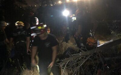 Members of the Israel Fire and Rescue Services prepare to enter a hole where a soldier fell into, near the town of Mevo Modi'im, August 1, 2022. (Fire and Rescue Services)