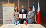 From left: IATI CEO and president Karin Mayer Rubinstein, Bahraini Ambassador to Israel Khaled Yousif Al-Jalahma, and Bahrain Fintech Bay CEO Bader Sater sign a fintech cooperation deal in Tel Aviv, August 2, 2022. (Alon Gilboa)