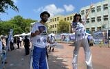 Performers on stilts welcome Likud primary voters in Rishon Lezion, August 10, 2022 (Carrie Keller-Lynn/Times of Israel)