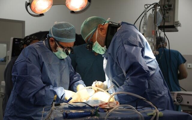 Rambam Health Care Campus physicians Dr. Shai Menachem, left, and Dr. Ory Keynan, perform back surgery using the anterior-to-psoas method for the first time in Israel. (Courtesy of Rambam Health Care Campus) Rambam Health Care Campus physicians Dr. Shai Menachem, left, and Dr. Ory Keynan, perform back surgery using the anterior-to-psoas method for the first time in Israel. (Courtesy of Rambam Health Care Campus)