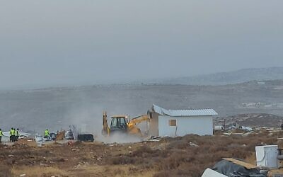 Security forces from the Civil Administration and the police demolish one of the homes in the illegal settlement outpost of Ramat Migron on August 30, 2022. (Courtesy Ramat Migron settlers)