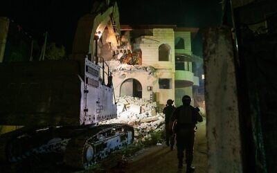 Military bulldozers demolish the home of a Palestinian accused of killing three Israelis in Elad earlier this year, in the West Bank town of Rummanah on August 8, 2022. (Israel Defense Forces)