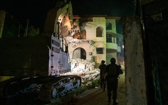 Military bulldozers demolish the home of a Palestinian accused of killing three Israelis in Elad earlier this year, in the West Bank town of Rummanah on August 8, 2022. (Israel Defense Forces) Military bulldozers demolish the home of a Palestinian accused of killing three Israelis in Elad earlier this year, in the West Bank town of Rummanah on August 8, 2022. (Israel Defense Forces)