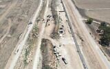 An aerial view shows security forces uncovering a Hamas tunnel along the northern Gaza border, in an image published by the IDF on August 15, 2022. The fence on the left is Israel's old barrier along the internationally recognized border, and the right fence is the new one, with the underground barrier. (Israel Defense Forces)