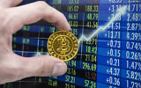 A golden bitcoin coin in front of a stock exchange chart (Getty Images)