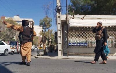 Taliban fighters block a road after a blast during Friday prayers at the Gazargah mosque, in Afghanistan's western city of Herat on September 2, 2022. (AFP)
