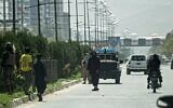 Taliban fighters (C) stand guard along a road near the Russian embassy after a suicide attack in Kabul on September 5, 2022. (Photo by Wakil KOHSAR / AFP)
