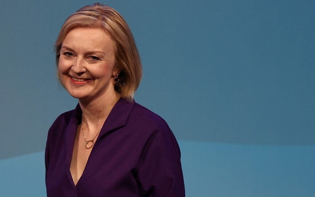 New Conservative Party leader and Britain's Prime Minister-elect Liz Truss smiles as she arrives on stage to deliver a speech at an event to announce the winner of the Conservative Party leadership contest in central London on September 5, 2022 (Adrian DENNIS/AFP)