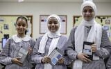 Students at a school run by the United Nations Relief and Works Agency for Palestine Refugees (UNRWA) pose with new electronic tablets in class, in Gaza City on September 7, 2022. (Photo by MOHAMMED ABED / AFP)
