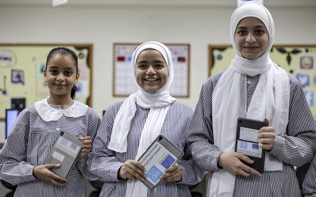 Students at a school run by the United Nations Relief and Works Agency for Palestine Refugees (UNRWA) pose with new electronic tablets in class, in Gaza City on September 7, 2022. (Photo by MOHAMMED ABED / AFP) Students at a school run by the United Nations Relief and Works Agency for Palestine Refugees (UNRWA) pose with new electronic tablets in class, in Gaza City on September 7, 2022. (Photo by MOHAMMED ABED / AFP)