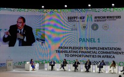 United Nation Special Envoy on Financing 2030 Agenda for Sustainable Development, Mahmoud Mohieldin of Egypt, is seen on screen as he talks during an African Ministers of Finance, Economy and Environment Meeting for the COP27 climate summit, in al-Masa hotel at the New Administrative Capital, some 45 kilometres east of Cairo, on September 7, 2022. (Khaled Desouki/AFP)