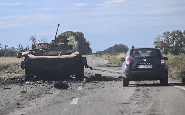 A car drives past a destroyed Russian armored vehicle in Balakliya, Kharkiv region, on September 10, 2022, amid the Russian invasion of Ukraine. (Photo by Juan BARRETO / AFP) A car drives past a destroyed Russian armored vehicle in Balakliya, Kharkiv region, on September 10, 2022, amid the Russian invasion of Ukraine. (Photo by Juan BARRETO / AFP)