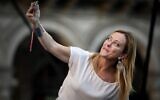 Leader of Italian far-right party Fratelli d'Italia (Brothers of Italy) Giorgia Meloni, takes a selfie during a rally as part of the campaign for general elections, in Piazza Duomo in Milan, Italy on September 11, 2022. (Piero Cruciatti/AFP)