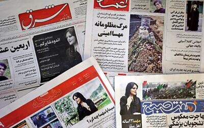 The front pages of Iranian newspapers featuring articles and photographs of Mahsa Amini, a woman who died three days after being arrested by the Islamic republic's 'morality police,' seen on September 18, 2022. (ATTA KENARE / AFP)